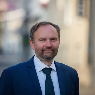 Mann med brunt hår og blå dress